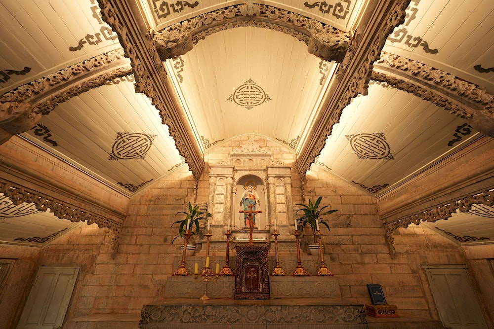 The intricately carved stone altar in the Church of the Sacred Heart features statues of the Virgin Mary 